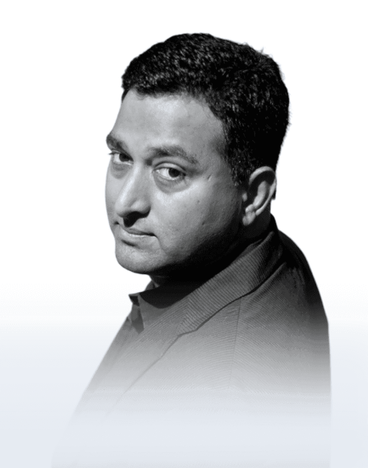 Black-and-white portrait of Ramesh Raskar glancing over his shoulder.