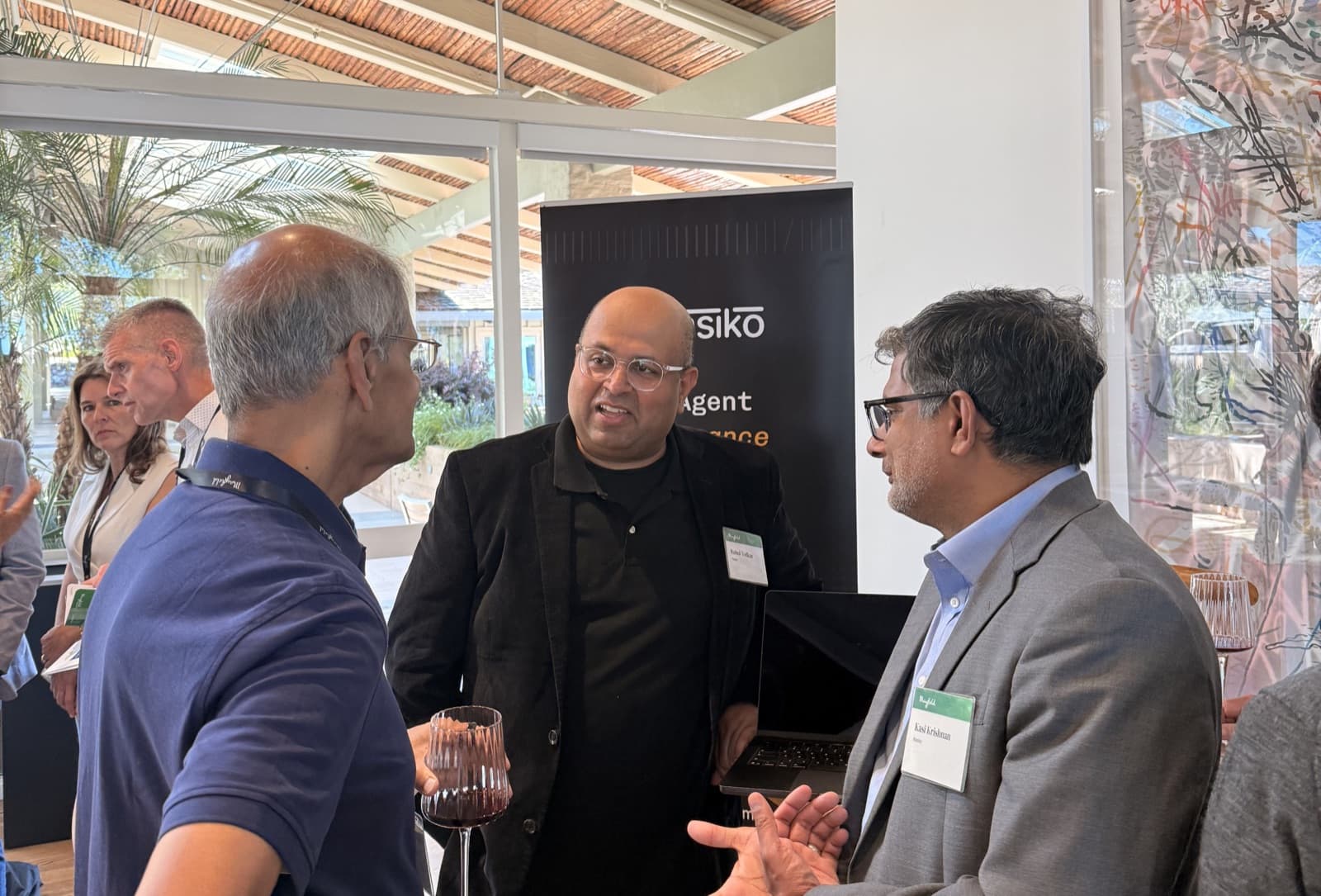 Conversations at the Nasiko booth at Berkeley RDI's Agentic AI Summit, in front of the Nasiko AI Agent Governance banner.