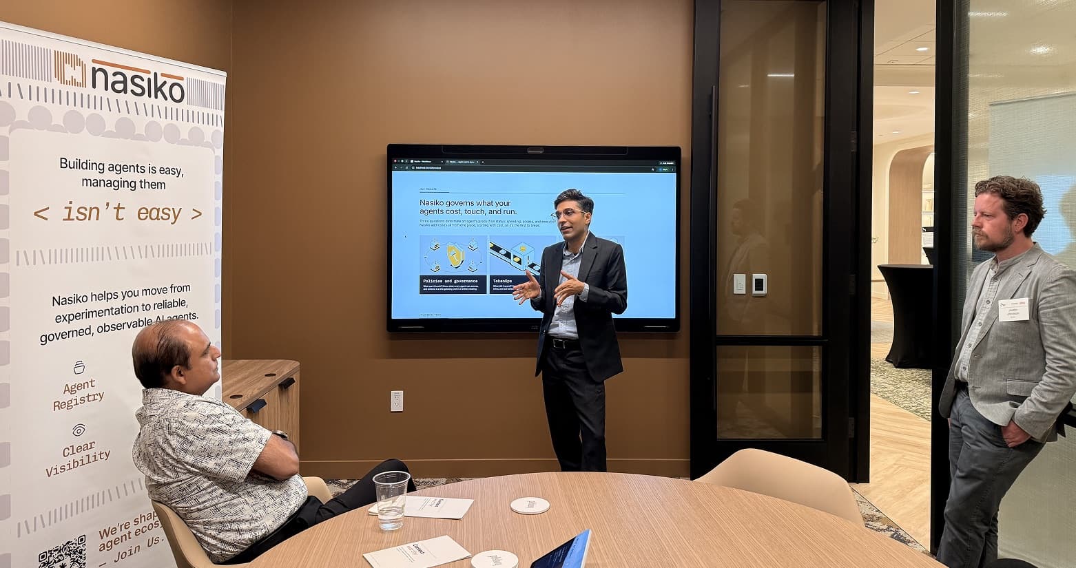 A live Nasiko product demo to executives at the MIT Media Lab event in Cambridge, beside the 'Building agents is easy, managing them isn't' banner.